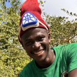 kwa simba tanzania pangani about us_ team oscar meada Oscar Meada camp manager: portrait with red beany on head looking in camera at kwa simba accommodation