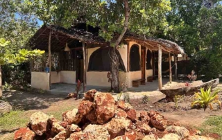 Outside terrace and garden of budget rooms made with natural materials in Kwa Simba accommodation in Pangani, Tanzania Africa.